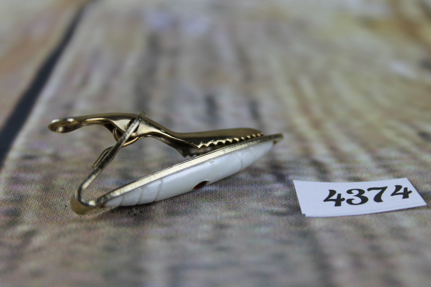 Vintage gold metal white lucite red diamante tie clip